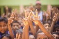 Children raising their hands showing victory sign Royalty Free Stock Photo