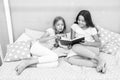 Children read book in bed. Family tradition. Girls best friends read fairy tale before sleep. Best books for kids Royalty Free Stock Photo