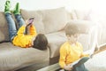 Children read a book and play by phone