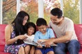 Children read a story book with parents