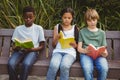 Children reading books at park Royalty Free Stock Photo