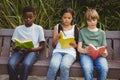 Children reading books at park