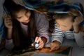 Children reading at night Royalty Free Stock Photo