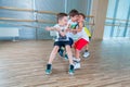 Children and recreation, group of happy multiethnic school kids playing tug-of-war with rope in gym Royalty Free Stock Photo