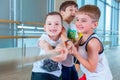 Children and recreation, group of happy multiethnic school kids playing tug-of-war with rope in gym Royalty Free Stock Photo