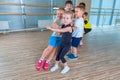 Children and recreation, group of happy multiethnic school kids playing tug-of-war with rope in gym Royalty Free Stock Photo