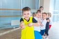 Children and recreation, group of happy multiethnic school kids playing tug-of-war with rope in gym Royalty Free Stock Photo