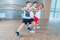 Children and recreation, group of happy multiethnic school kids playing tug-of-war with rope in gym Royalty Free Stock Photo