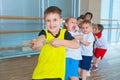 Children and recreation, group of happy multiethnic school kids playing tug-of-war with rope in gym Royalty Free Stock Photo