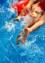 Children in the red inflatable mattress in pool