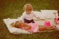 Children relax on green grass on summer day