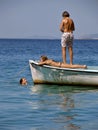 Children relaxing on boat in sea