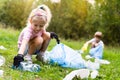 children remove plastic garbage and put it in a biodegradable garbage bag in the open air. The concept of ecology, waste