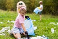 children remove plastic garbage and put it in a biodegradable garbage bag in the open air. The concept of ecology, waste