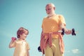 Children repeat exercise after Granddad. Healthy family lifestyle. Family Sport. Grandfather and child lifting dumbbell