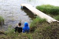 Children rest on shore of lake