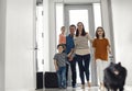 Children returning home with parents mom and dad, smiling cute children brother and sisters