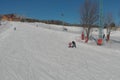 Children ride for adults skier in ski resort Royalty Free Stock Photo