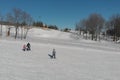 Children ride for adults skier in ski resort Royalty Free Stock Photo