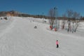 Children ride for adults skier in ski resort Royalty Free Stock Photo