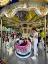 Budva, Montenegro - 07.07.22: Children ride on an Alice in Wonderland themed carousel