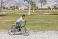 Children ride a bike. Mongolia, Altai. Mongolian nomads