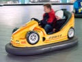 Children ride a children`s amusement ride electric cars Royalty Free Stock Photo