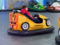 Children ride a children`s amusement ride electric cars Royalty Free Stock Photo