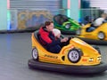 Children ride a children`s amusement ride electric cars Royalty Free Stock Photo