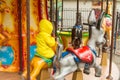 Children ride on the horses on the colorful carousel in the Park Royalty Free Stock Photo