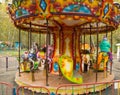 Children ride on the horses on the colorful carousel in the Park Royalty Free Stock Photo