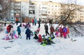 Children ride with icy mountain