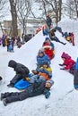 Children ride with a snow slide