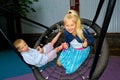 Children ride on a swing Royalty Free Stock Photo