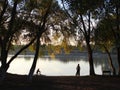 Children ride their bicycles on the bank of the river