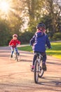 Children riding bicycles in a park Royalty Free Stock Photo