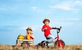 Children riding bikes - kids ready for work on farm. Childhood on countryside. Summer at countryside. Eco life. Carefree Royalty Free Stock Photo