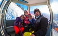 Children riding cabin cable car on winter vacation skiing