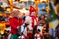 Children riding carousel on Christmas market Royalty Free Stock Photo