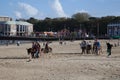 Children riding donkeys on Weymouth Beach in Dorset in the UK