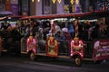 Children riding the pleasure train for excursions on the evening street. Kyiv, Ukraine