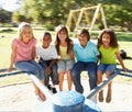 Children Riding On Roundabout In Playground