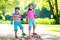 Children riding skateboard in summer park Royalty Free Stock Photo