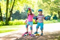 Children riding skateboard in summer park Royalty Free Stock Photo