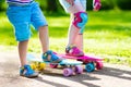 Children riding skateboard in summer park Royalty Free Stock Photo