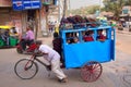 Children riding to school with cycle rickshaw, Delhi, India