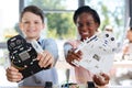 Children with robot models smiling at the camera