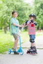 Children on the rollers and the scooters drink bottled water