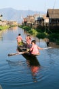 Children on rowing a boat at the village of Maing Thauk