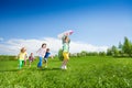 Children run after boy holding rocket carton toy Royalty Free Stock Photo